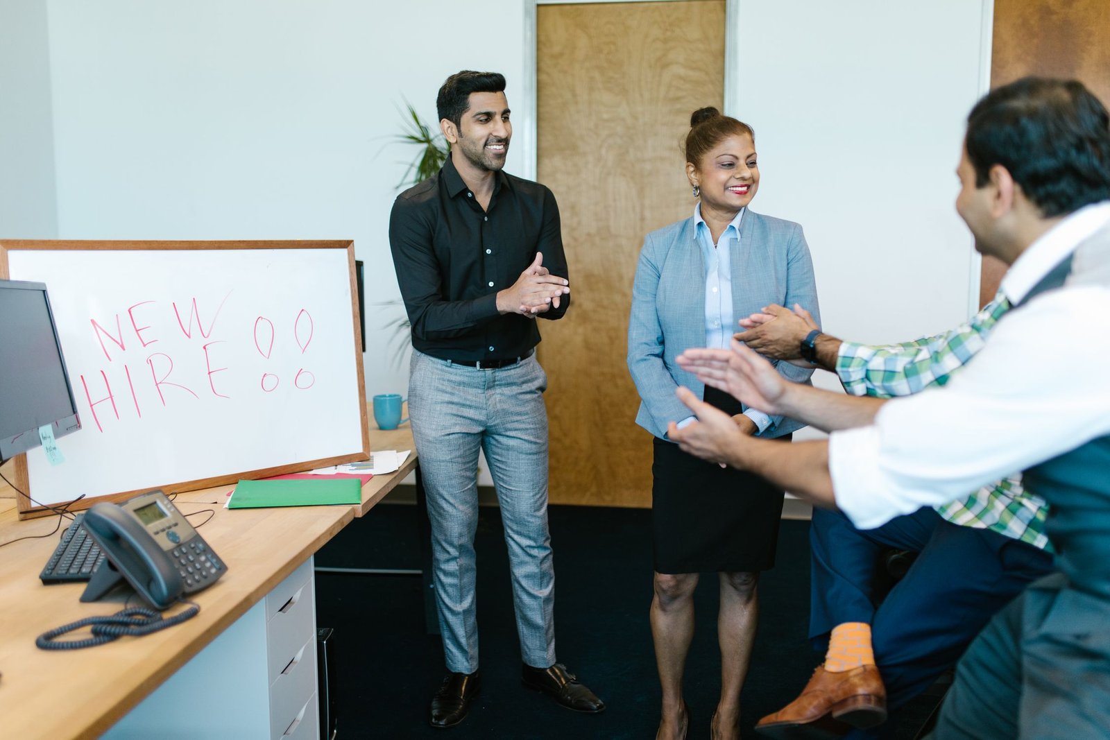 How to Hire Your First Employee in a UAE Free Zone in 2026: Work Permits, Visa Quotas, and Real Costs Business team meeting to discuss hiring in a UAE free zone office 2026