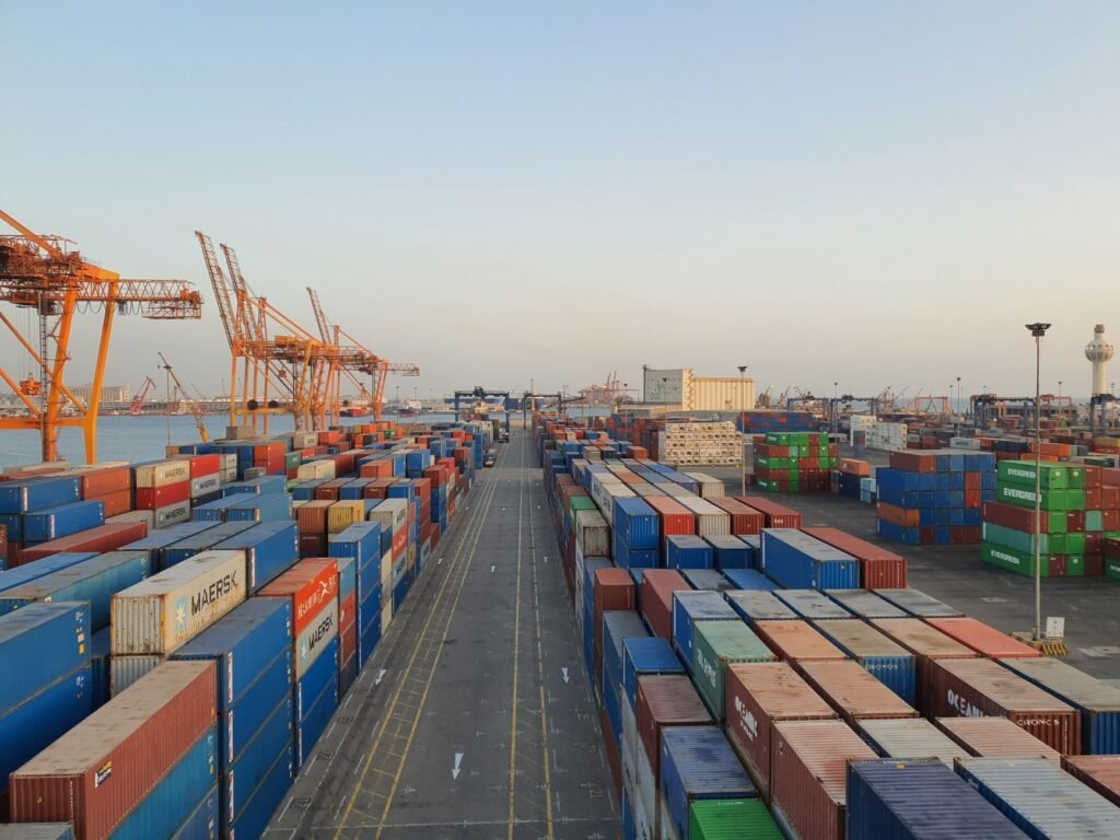 Cargo containers at sunrise at a UAE free zone port — import export business setup UAE