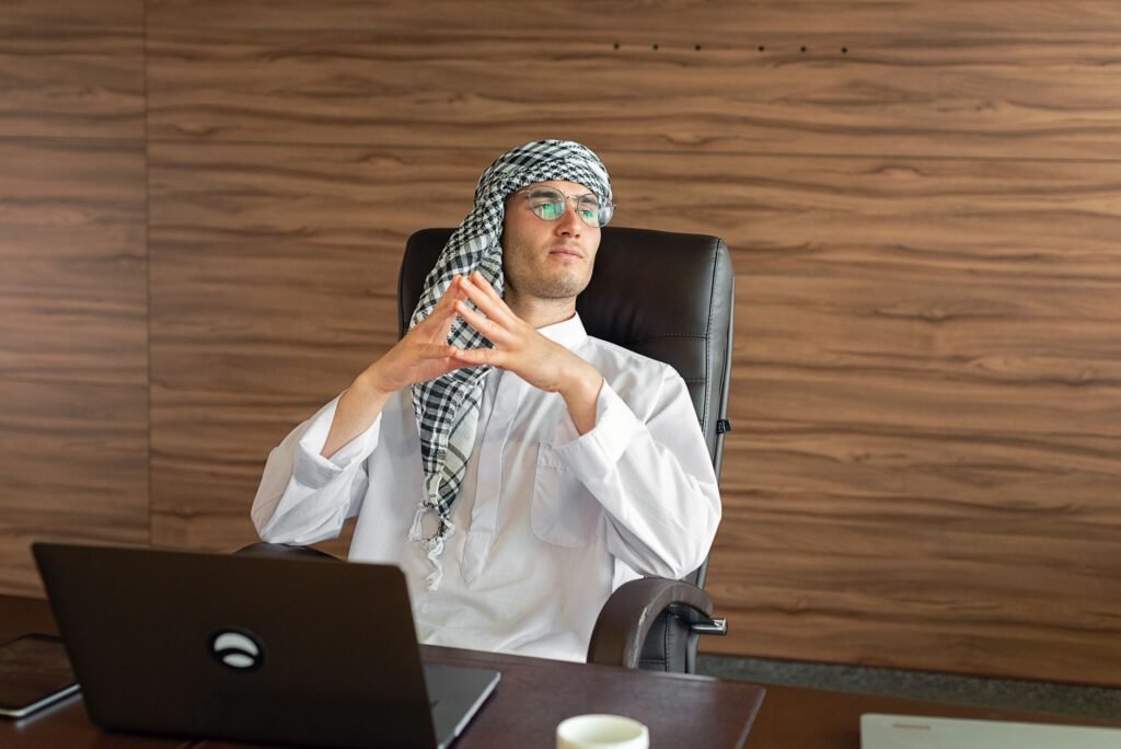 UAE free zone for Iraqi nationals - Middle Eastern entrepreneur working at laptop in modern office