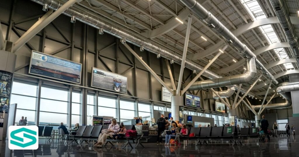 UAE Visa Status Change 2026: Process, Costs and How to Apply - spacious airport terminal interior with passengers seated