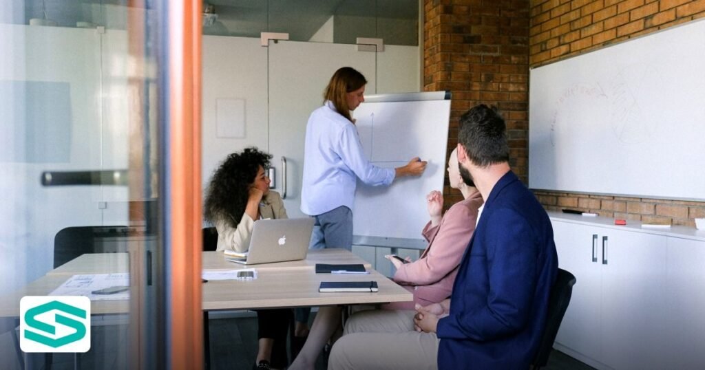 How to Change Company Manager in a Free Zone – Step‑by‑Step Guide - concentrated colleagues sitting at table in modern