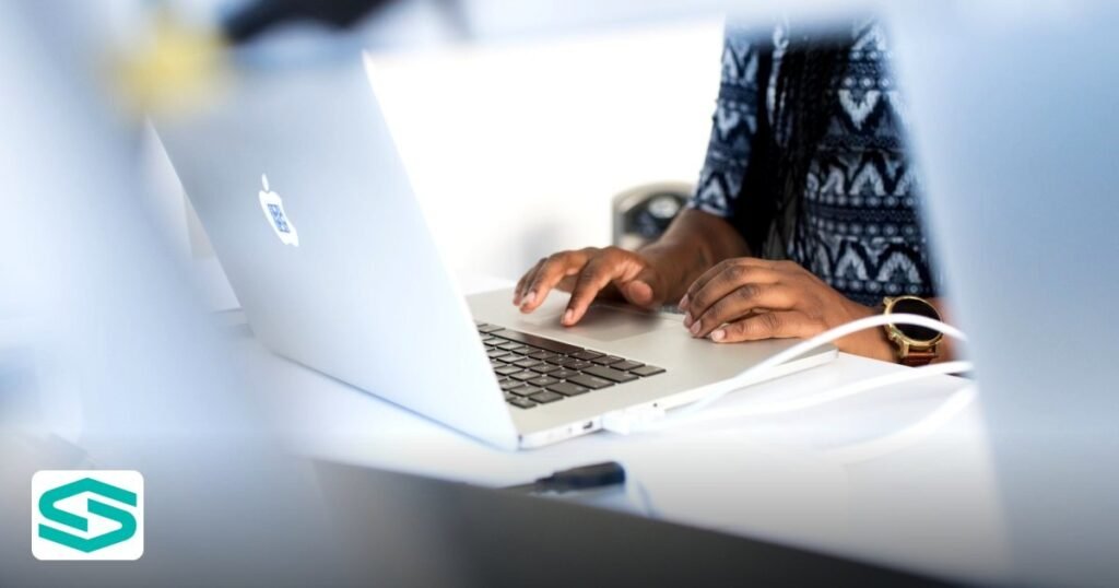 Do I Need a Local Sponsor to Start a Business in UAE? – Your Guide - woman typing on a laptop at a desk in a modern office