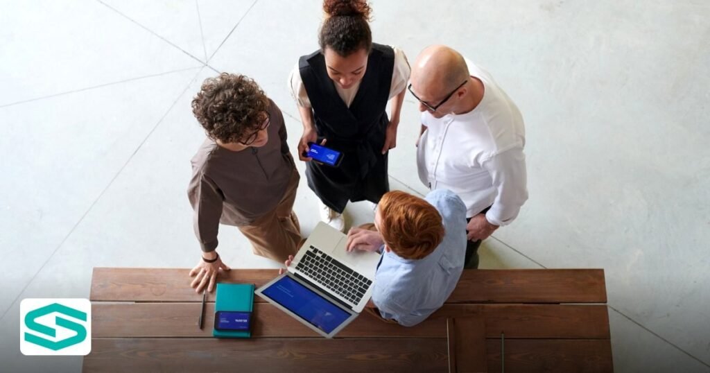 Essential E‑commerce Marketplace Abu Dhabi Free Zone Checklist 2026 - high angle view of colleagues discussing work around