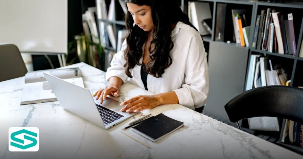 How to Secure an AI R&D Free Zone License UAE in 2026 - confident businesswoman working on her laptop in a modern