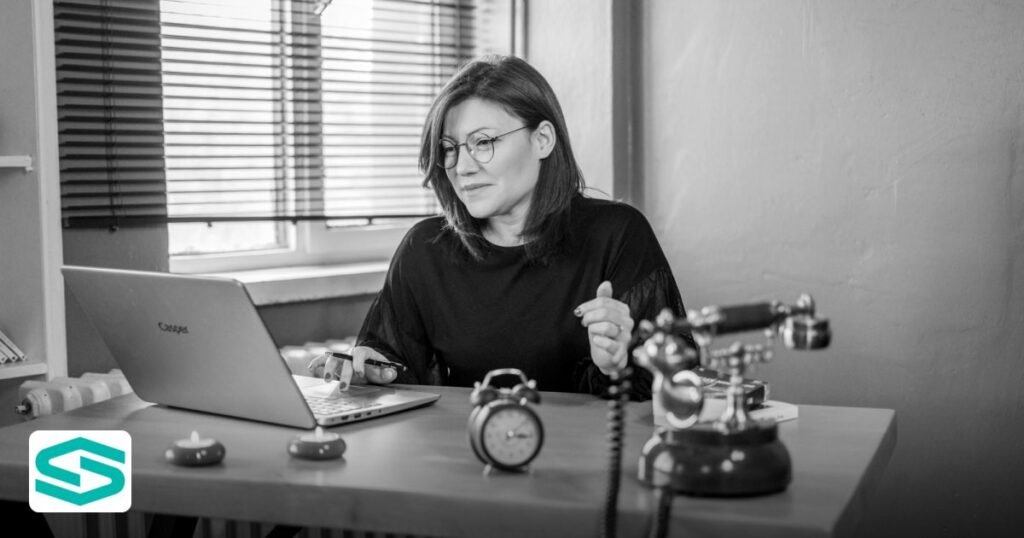 Trademark Registration UAE Free Zone: A 2026 Guide - black and white photo of a woman working at a desk with a laptop