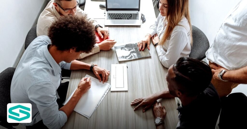 Securing UAE Free Zone VC Funding: A 2026 Startup Guide - group of diverse professionals collaborating in a modern office