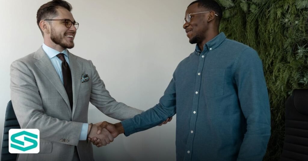 2026 UAE Tax Reforms Free Zone Business Impact - two businessmen smiling and shaking hands
