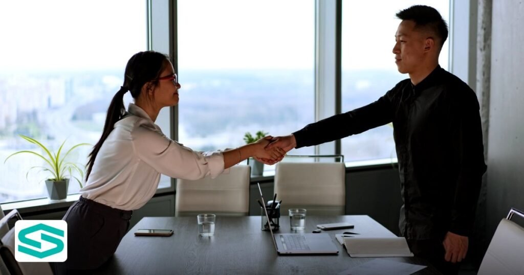 UAE Data Localization for SaaS in Free Zones 2026 Guide - professional coworkers exchange a handshake in a modern corporate