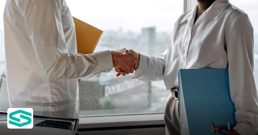RAK ICC vs Dubai Mainland Holding Company Setup: Which is Best? - two professionals in business attire shaking hands