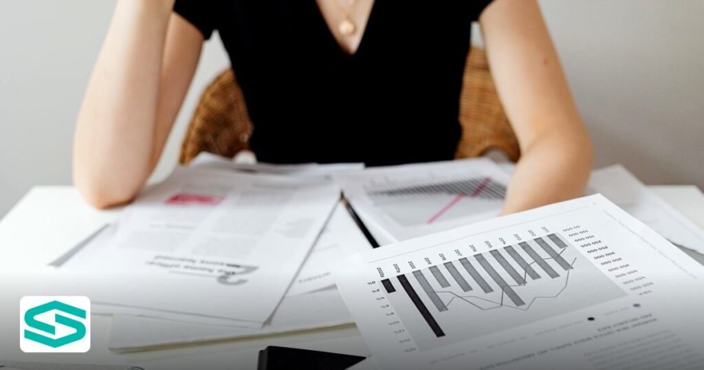 EmaraTax Corporate Tax Registration Steps – A Complete Guide - close-up of financial documents and graphs on a desk
