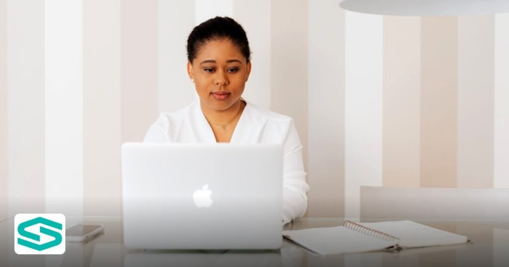 Establishment Card UAE: Labour Card Differences Explained - black woman working on a laptop in a modern office environment