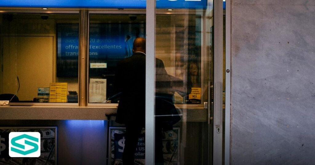 Non-Resident Business Bank Account for Free Zone Firms - man at a currency exchange office window, showing currency rates