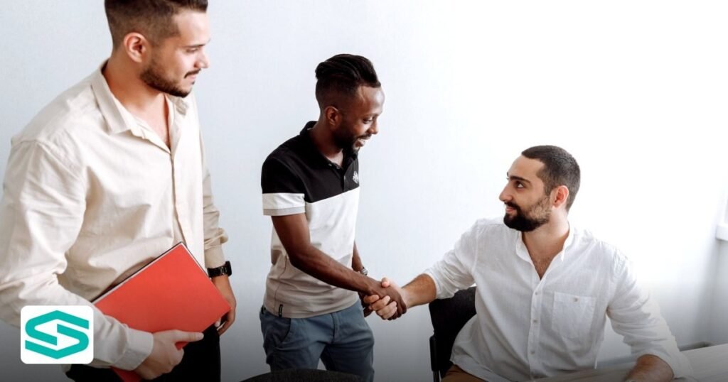 2026 GCC VAT SaaS UAE free zone: What Subscription Firms Must Know - three men in an office setting, shaking hands