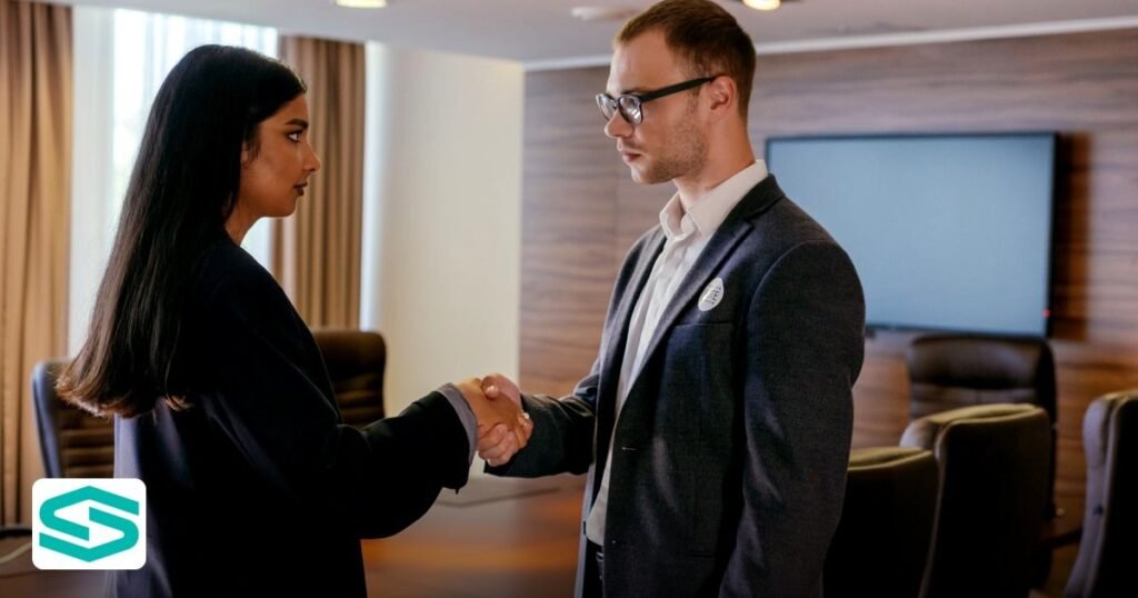 Share Transfer Free Zone Company UAE: Process & Required Documents - two professionals shaking hands in a modern