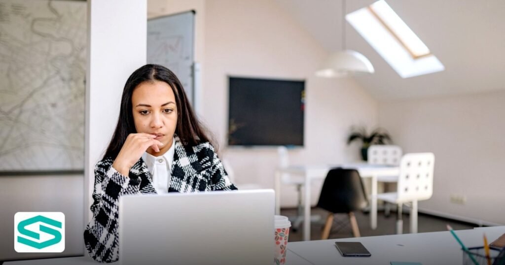UAE Trade Name Rules and Common Rejections - woman in stylish office working on laptop with natural lighting